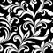 Elegant seamless pattern. Tracery of swirls and decorative leaves on a black background. Vintage style.