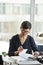 Elegant senior businesswoman working with documents at desk in office