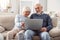 Elegant senior couple watching pictures in the social media