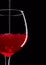 Elegant silhouette glass of red wine on black background