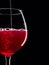 Elegant silhouette glass of red wine on black background