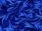 Elegant silk fabric backgrounds. Metallic color of shiny textile, soft blue texture. Satin folds, waves seamless pattern.