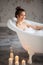 Elegant smiling woman taking a bath in modern rest room