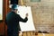 Elegant speaker lecturer holding marker at empty white board, at