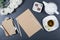 Elegant still life - sheet of brown craft paper, white chrysanthemums, pencils, teapot, cup of herbal tea and candies on gray