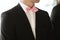 Elegant and stylish best men in black suits and pink bowties closeup