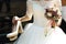 Elegant stylish bride in white vintage wedding dress shoes and b