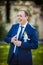 Elegant stylish gorgeous groom with veil on the background of tr