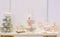 Elegant sweet table with big cake, cupcakes, cake pops on dinner