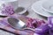 Elegant table setting for breakfast, with flowers lilacs