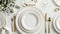 Elegant table setting with gold cutlery and white porcelain plates
