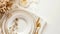 Elegant table setting with gold cutlery and white porcelain plates