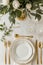 Elegant table setting with gold cutlery and white porcelain plates