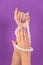 Elegant Touch: Lilac Manicure and Pearl Necklace