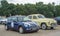 Elegant vintage old yellow Polish car Warszawa M20 and blue Mini Cooper parked