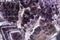 Elegant violet amethyst texture with cracks on surface.
