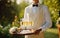 Elegant waiter serving champagne at outdoor wedding celebration, generative Ai
