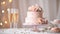 Elegant wedding cake adorned with roses. Champagne glasses.