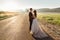 Elegant wedding couple stands tired on the road