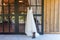 Elegant wedding dress hanging on the window and cowboy boots next to it