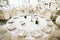 Elegant wedding reception white table arrangement restaurant, candlestick on table. Plates, forks and glasses