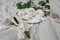 Elegant wedding still life, tableware set. Plate, golden cutlery, delicate pink nude colored roses. Beige linen