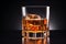 Elegant whisky glass isolated on black background with ample copy space for creative text placement