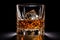 Elegant whisky glass isolated on a dark black background with ample copy space for text placement