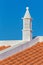 Elegant white chimney on orange roof