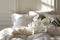 Elegant white orchids nestled on cozy linen pillows, basking in soft daylight