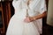 Elegant white wedding dress at bride morning on hands