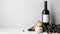 Elegant wine and cheese setup with grapes and almonds, blank label bottle for branding