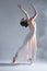 Elegant woman ballerina dancer isolated on grey background