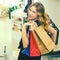 Elegant woman with bright makeup holds shopping bags. Black Friday. Fashion successful young woman at store. Great shopping time.