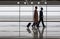 Elegant woman is carrying baggage with her colleague male