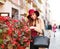 Elegant woman in coat and purple hat on street tourist town with