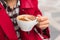 Elegant woman drinking latte coffee cup at luxury cafe coffee shop outdoor on city street. Morning breakfast enjoying a hot coffee