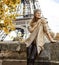 Elegant woman on embankment in Paris, France looking aside