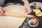 Elegant woman hand holding a rolling pin and prepares the dough for buns. Step by step recipe
