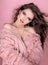 Elegant woman in pink fur coat in fashion style