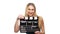 Elegant woman with red lips go, using clapper board and smiling, on white