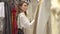 Elegant woman shopping for clothes in boutique