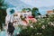 Elegant woman with straw hat and white clothes enjoying view of colorful village Assos on sunny day. Stylish female visiting