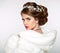 Elegant woman in white fur coat. Wedding Hairstyle. Beautiful fa