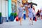 Elegant women walking colorful city street