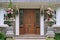 elegant wood grain front door and tall flower pots