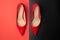 Elegant worn red shoes on a black-red background. Lifestyle. Everyday life woman