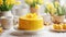 Elegant yellow fondant cake decorated with fresh tulips and Easter eggs in a white bowl, on table. Happy Easter concept