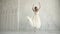 Elegant young ballerina dancing ballet in a light dress and Pointe. beauty and grace of youth. slow motion