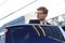 Elegant young businessman entering his car while standing outdoors